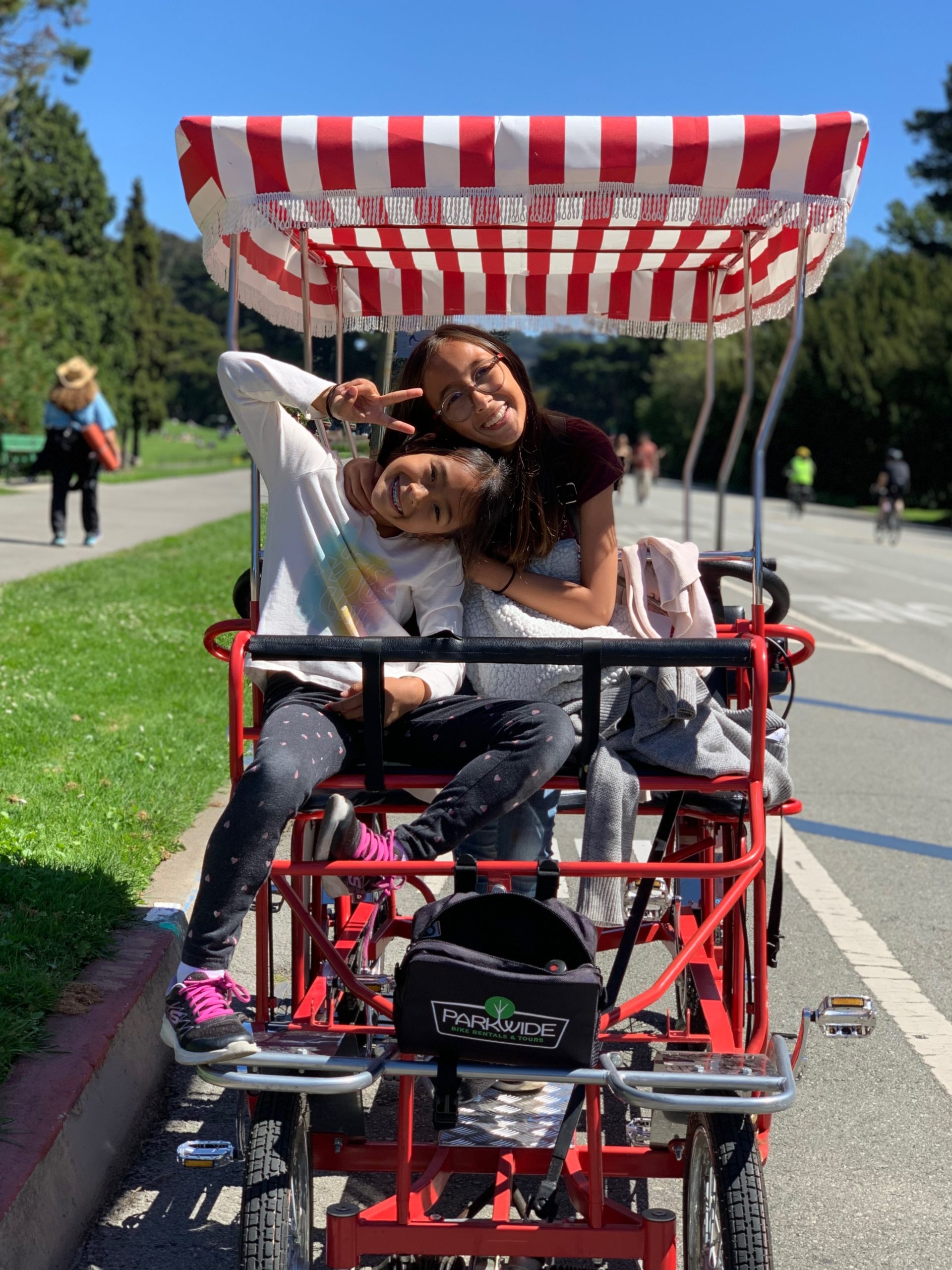 Two girls on a surrey bike in Golden Gate Park