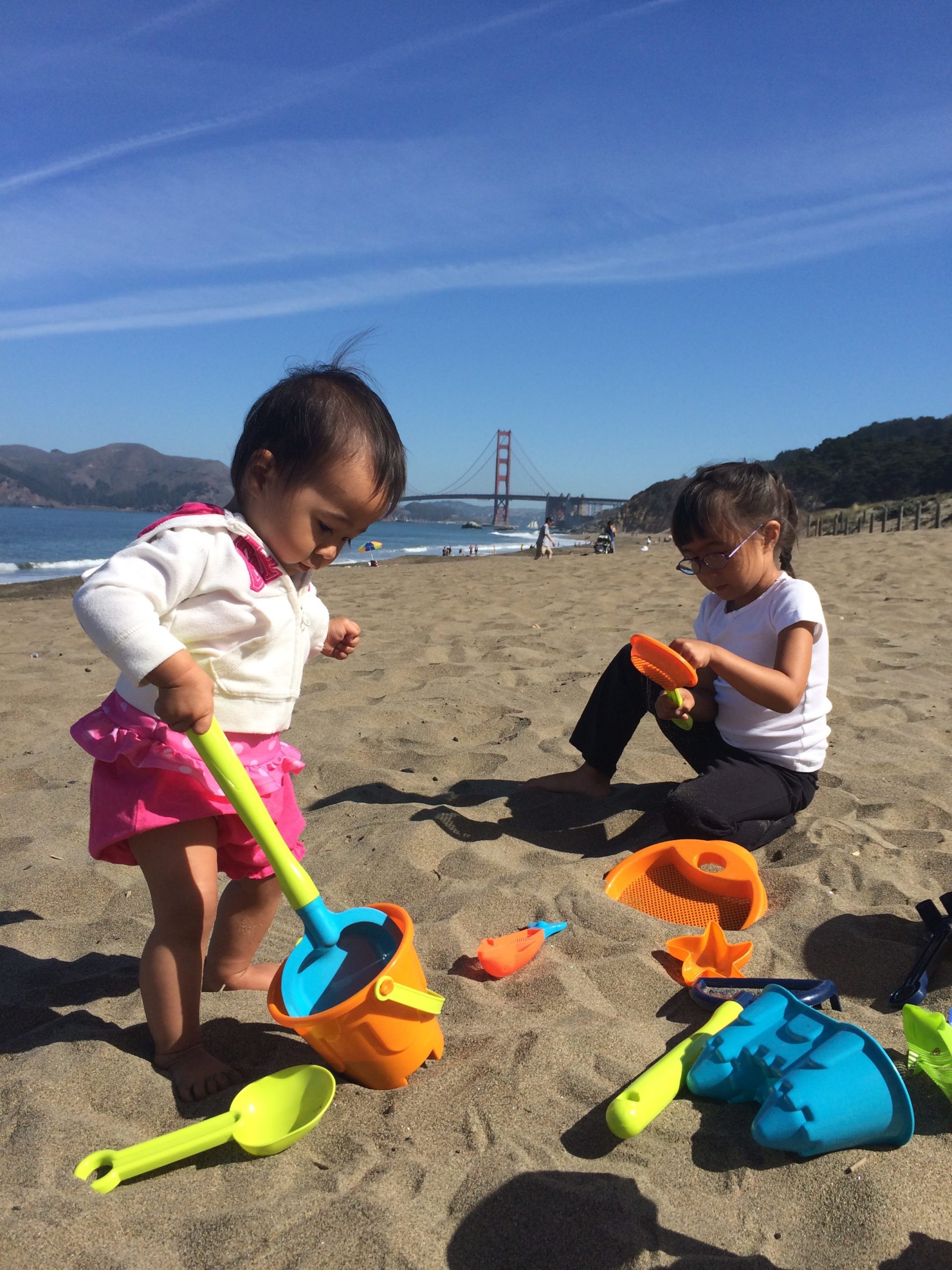 girls playing with sand toys at Baker Beach San FRancisco