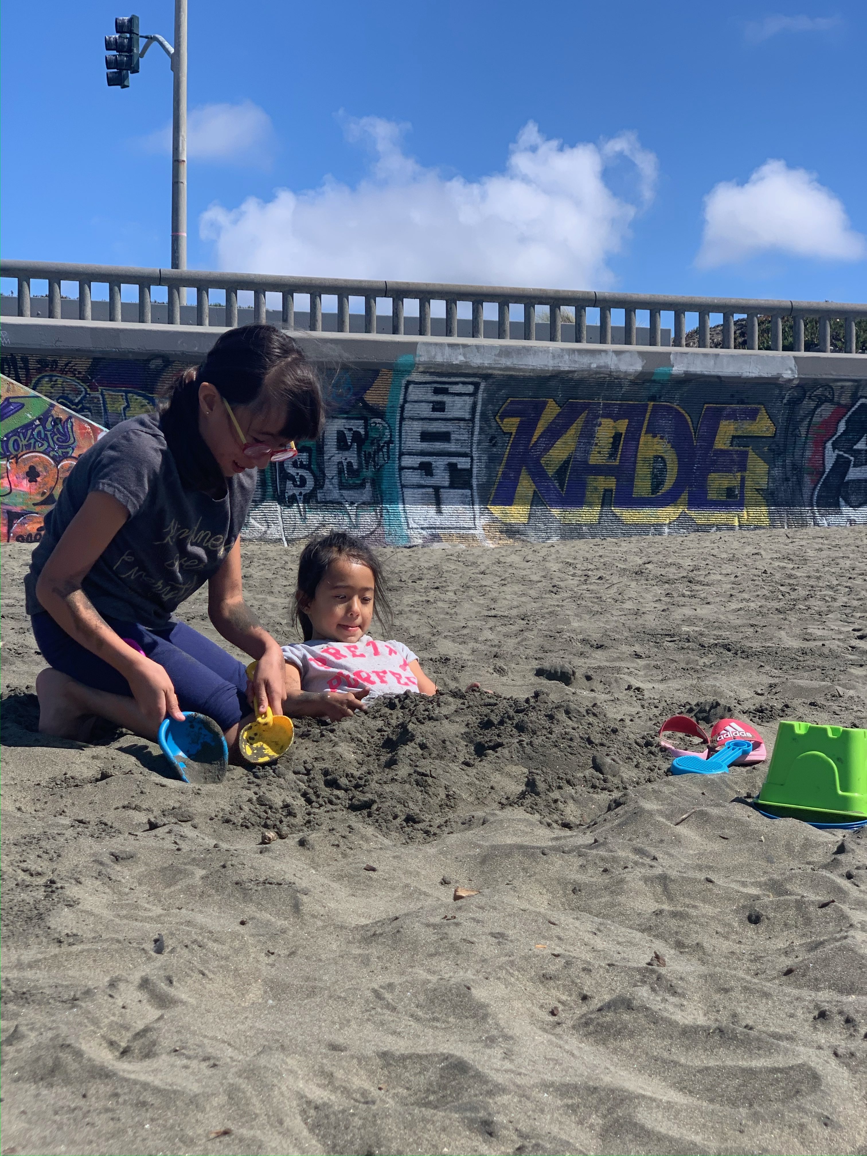 two girls playing in the sand at Ocean Beach San Francisco