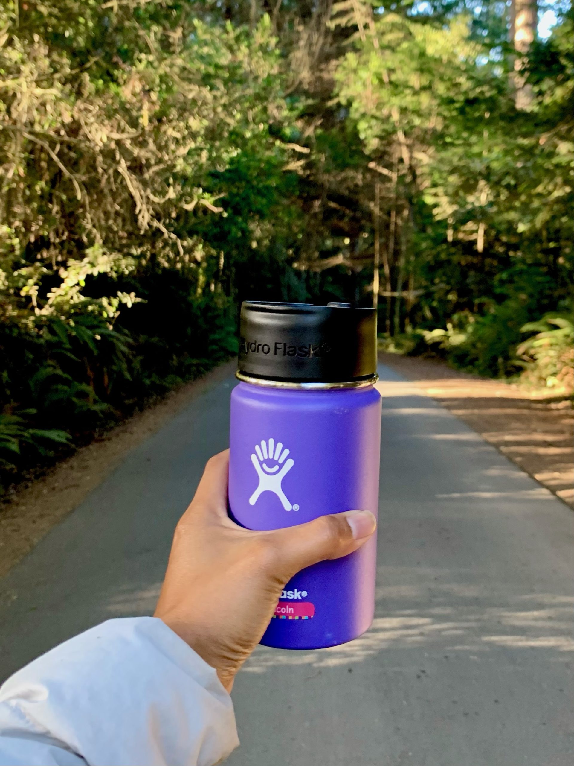 hand holding a purple hydroflask tumbler at Mendocino Grove California