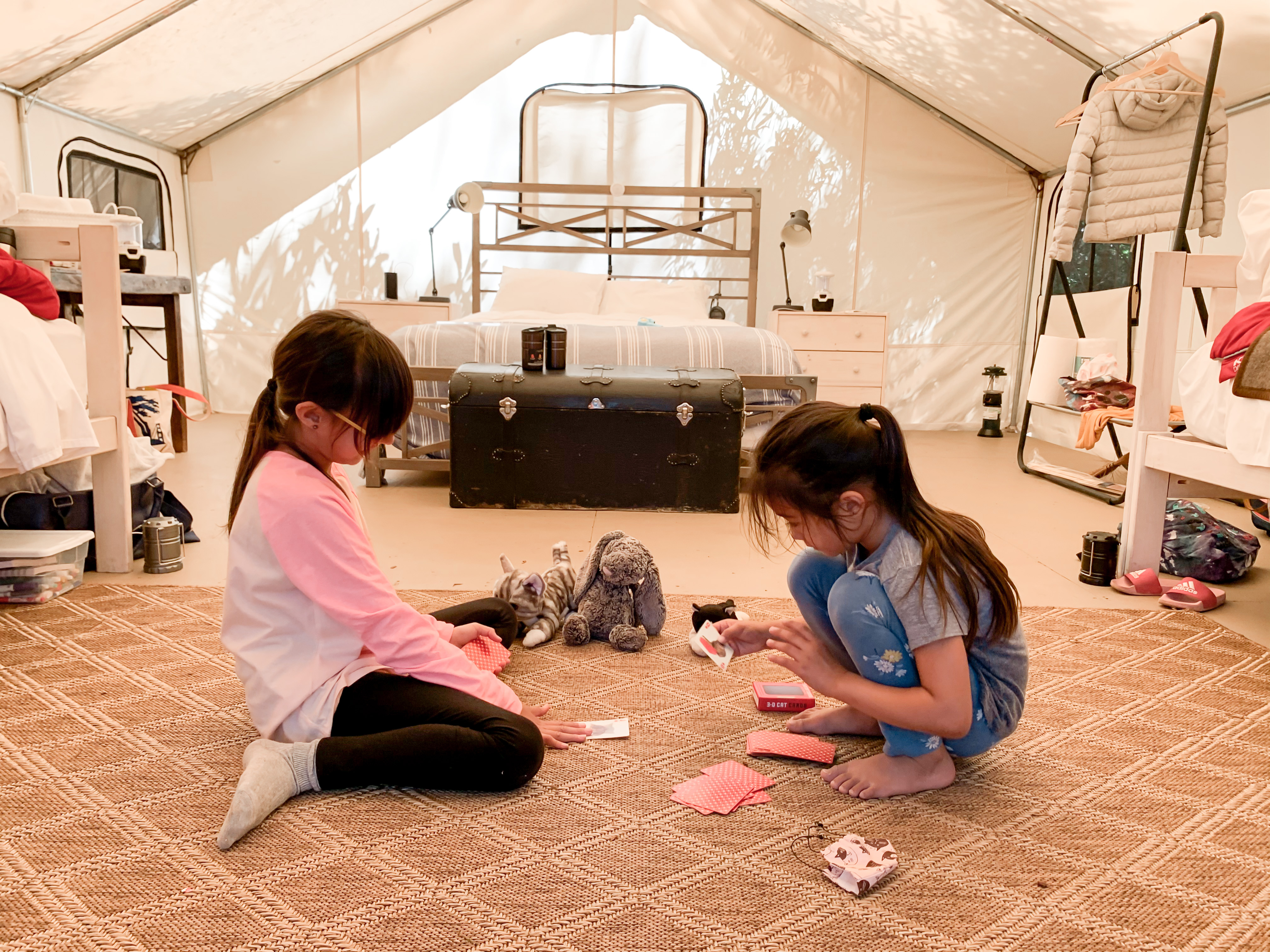 two girls playing a game in their tent at Mendocino Grove